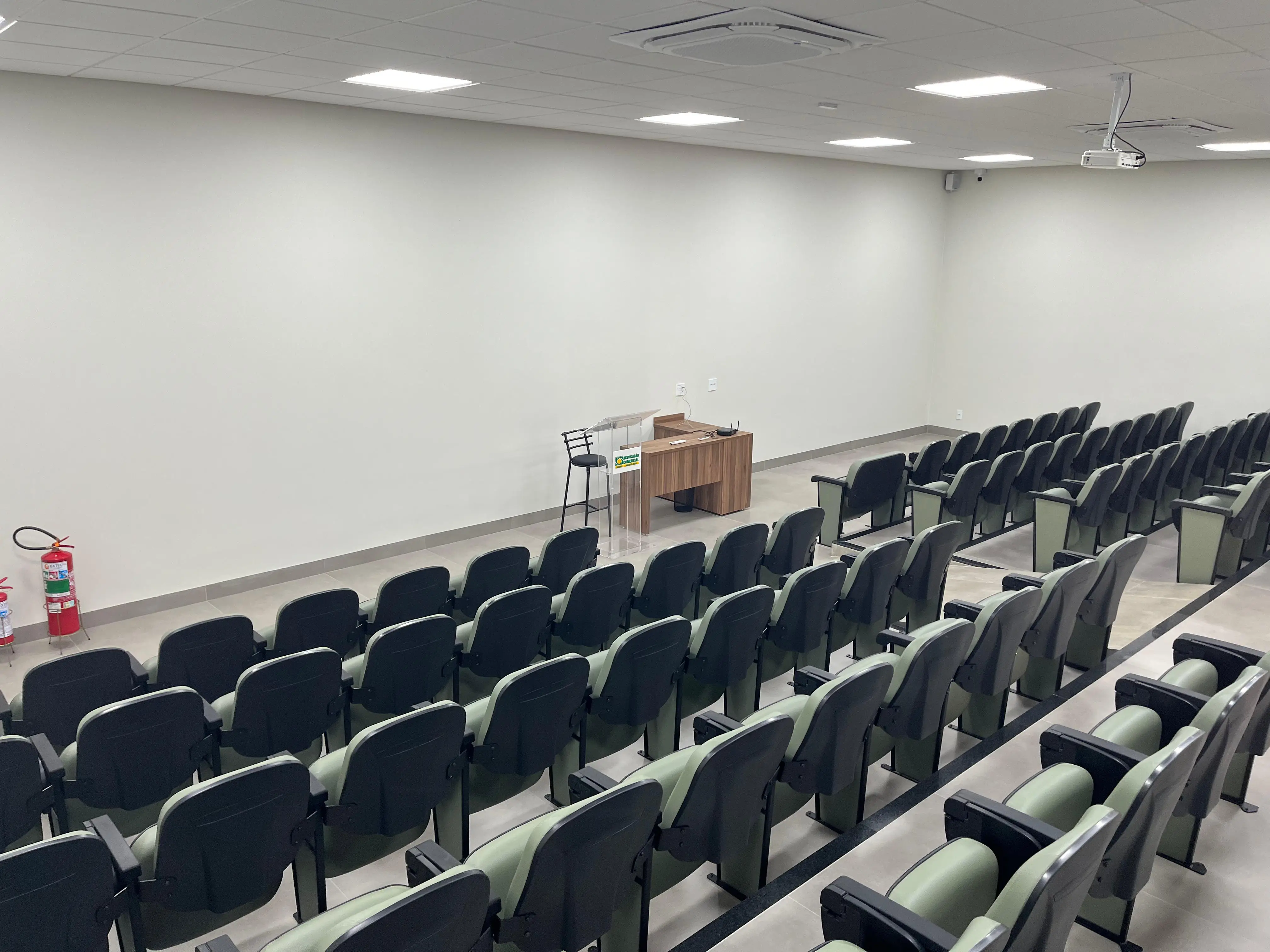 Mesa de palestrante e tela de projeção do auditório